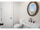 Small bathroom with pedestal sink, toilet, and oval mirror at 89 Batten Board Way, Woodstock, GA 30189