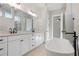 Elegant bathroom boasts double vanity, soaking tub, and modern fixtures at 89 Batten Board Way, Woodstock, GA 30189