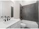 Bathroom with gray tile shower, white vanity and bathtub at 89 Batten Board Way, Woodstock, GA 30189