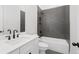 Bathroom with white vanity, dark gray tile shower, and bathtub at 89 Batten Board Way, Woodstock, GA 30189