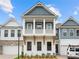 Two-story craftsman style home with gray and white exterior, two-car garage, and landscaped front yard at 89 Batten Board Way, Woodstock, GA 30189