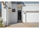 White brick exterior with a black front door and two-car garage at 89 Batten Board Way, Woodstock, GA 30189