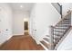 Hardwood floor hallway with doors to bedrooms and bathroom at 89 Batten Board Way, Woodstock, GA 30189