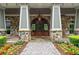 Elegant home entrance with stone facade and arched door at 89 Batten Board Way, Woodstock, GA 30189