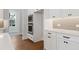 Built-in wall oven and microwave, white cabinets and wood flooring at 89 Batten Board Way, Woodstock, GA 30189