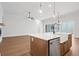 Open concept kitchen with island, white cabinets, and hardwood floors at 89 Batten Board Way, Woodstock, GA 30189