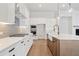 Open kitchen with gas cooktop, white cabinets, and a large island at 89 Batten Board Way, Woodstock, GA 30189