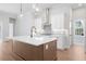 Modern kitchen with white cabinets, quartz countertops and a farmhouse sink at 89 Batten Board Way, Woodstock, GA 30189