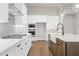 Modern kitchen with white cabinets, gas cooktop and hardwood floors at 89 Batten Board Way, Woodstock, GA 30189