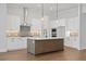 Modern kitchen featuring white cabinets, quartz countertops, and a large island at 89 Batten Board Way, Woodstock, GA 30189