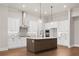 Modern kitchen with white cabinets, quartz countertops, and a large island at 89 Batten Board Way, Woodstock, GA 30189