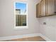 Laundry room with upper cabinets and window at 89 Batten Board Way, Woodstock, GA 30189