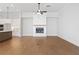 Living room with hardwood floors, fireplace, and kitchen island view at 89 Batten Board Way, Woodstock, GA 30189