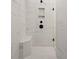 Modern shower with marble tile, built-in seat, and glass enclosure at 89 Batten Board Way, Woodstock, GA 30189