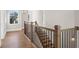 Elegant staircase with wooden railing and metal balusters at 89 Batten Board Way, Woodstock, GA 30189