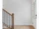 Wooden staircase with black metal railing in a light-colored hallway at 89 Batten Board Way, Woodstock, GA 30189