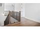 View of an upper hallway with wood floors and iron railing at 89 Batten Board Way, Woodstock, GA 30189