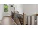 Bright hallway with wood floors and elegant staircase at 89 Batten Board Way, Woodstock, GA 30189