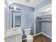 Bathroom with vanity, toilet, and laundry shelving at 1016 Old Holcomb Bridge Rd, Roswell, GA 30076