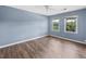 Spacious bedroom with light blue walls and wood-look flooring at 1016 Old Holcomb Bridge Rd, Roswell, GA 30076