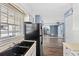 Kitchen with double sink, stainless steel appliances, and mirrored wall at 1016 Old Holcomb Bridge Rd, Roswell, GA 30076