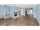 Living room with fireplace, stairs, and wood-look floors at 1016 Old Holcomb Bridge Rd, Roswell, GA 30076