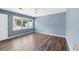 Bright living room with light blue walls and wood flooring at 1016 Old Holcomb Bridge Rd, Roswell, GA 30076