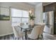 Dining room with dark wood table, light-colored chairs, and a modern chandelier at 236 Hickory Commons Way, Canton, GA 30115