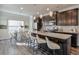 Modern kitchen with dark cabinets, granite counters, and stainless steel appliances at 236 Hickory Commons Way, Canton, GA 30115