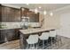 Modern kitchen with island, granite countertops, and dark brown cabinets at 236 Hickory Commons Way, Canton, GA 30115