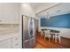 Bright dining area adjacent to a modern kitchen featuring stainless steel appliances at 245 Winding River Dr # E, Atlanta, GA 30350