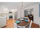 Bright dining area open to kitchen, featuring a hardwood floors and white wainscoting at 245 Winding River Dr # E, Atlanta, GA 30350