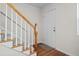 Welcoming foyer with hardwood floors, staircase, and a white front door providing a bright entrance at 245 Winding River Dr # E, Atlanta, GA 30350