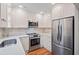 Modern white kitchen with stainless steel appliances and a decorative tile backsplash at 245 Winding River Dr # E, Atlanta, GA 30350