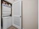 Efficient laundry area with stacked washer and dryer for convenient in-home laundry at 245 Winding River Dr # E, Atlanta, GA 30350