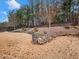 Landscaped backyard with tiered gardens and wooden fence at 3578 Crayton Glen Way, Buford, GA 30519