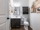 Small bathroom with dark vanity, toilet and wall cabinet at 3578 Crayton Glen Way, Buford, GA 30519