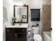 Bathroom with dark vanity, toilet and shower/tub combo at 3578 Crayton Glen Way, Buford, GA 30519