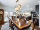 Elegant dining room featuring a large table, chandelier, and access to the kitchen at 3578 Crayton Glen Way, Buford, GA 30519