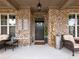 Front porch with seating area and a welcome sign at 3578 Crayton Glen Way, Buford, GA 30519