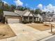 Two-story house with a three-car garage and manicured lawn at 3578 Crayton Glen Way, Buford, GA 30519