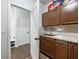 Well-lit laundry room with sink and cabinets at 3578 Crayton Glen Way, Buford, GA 30519