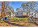 House with backyard, deck, and partial view of trees at 1271 Lorenzo Sw Dr, Atlanta, GA 30310