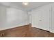 Well-lit bedroom featuring hardwood floors and access to another room at 1271 Lorenzo Sw Dr, Atlanta, GA 30310