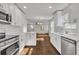 Bright kitchen boasts white cabinets, stainless steel appliances, and hardwood floors at 1271 Lorenzo Sw Dr, Atlanta, GA 30310