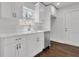 Close-up of the kitchen area with white cabinets, stainless steel dishwasher, and sink with modern fixtures at 1271 Lorenzo Sw Dr, Atlanta, GA 30310