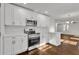 Modern kitchen featuring white cabinets, stainless steel appliances, and hardwood floors at 1271 Lorenzo Sw Dr, Atlanta, GA 30310