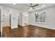 Spacious main bedroom featuring wood floors, ceiling fan, neutral walls, and ensuite bath at 1271 Lorenzo Sw Dr, Atlanta, GA 30310