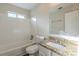 Bathroom featuring a granite vanity top and a white tiled tub and shower combo at 3950 Fennel Sw Cir, Atlanta, GA 30331