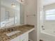 Bathroom featuring granite countertops, white cabinets, and a tiled shower-tub combo at 3950 Fennel Sw Cir, Atlanta, GA 30331